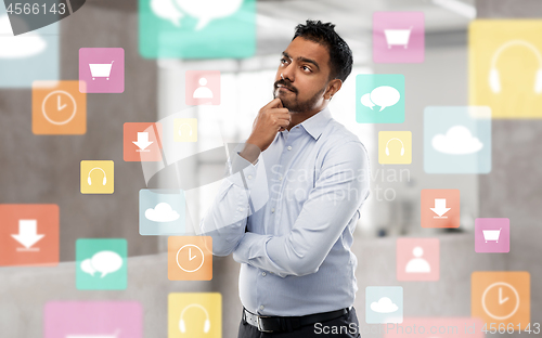 Image of indian businessman thinking with app icons