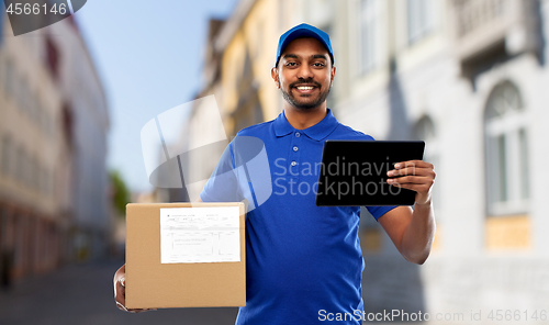 Image of delivery man with tablet pc and parcel in city