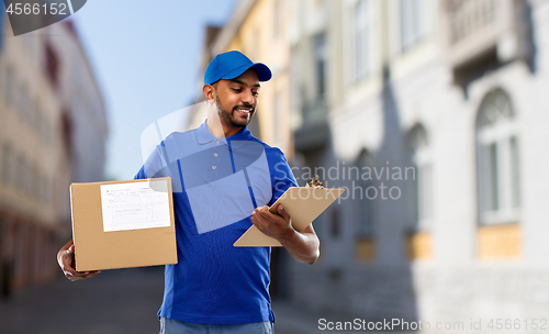 Image of delivery man with parcel and clipboard in city