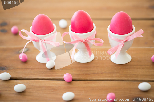 Image of easter eggs in holders and candy drops on table