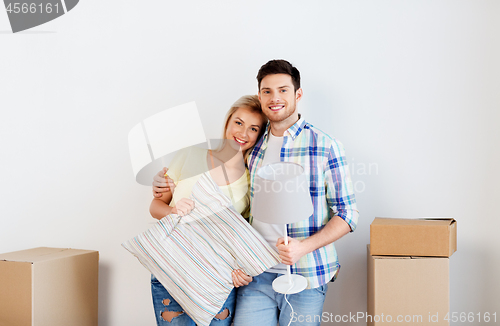 Image of couple with pillow and lamp moving to new home