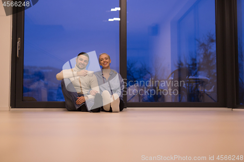 Image of happy couple in front of fireplace