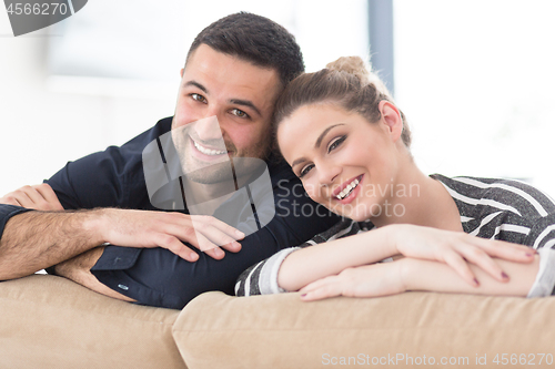 Image of Portrait of young couple sitting on sofa