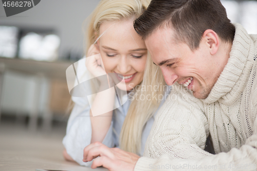 Image of Young Couple using digital tablet on cold winter day