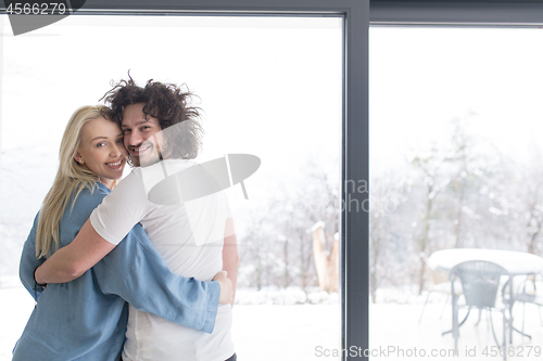Image of young couple enjoying morning coffee by the window