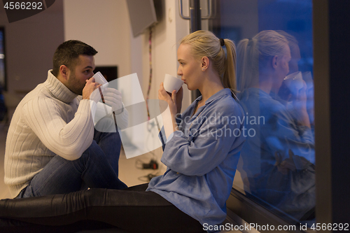 Image of happy couple in front of fireplace