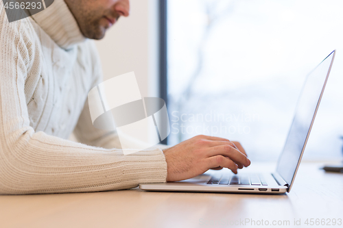 Image of businessman working using a laptop in startup office