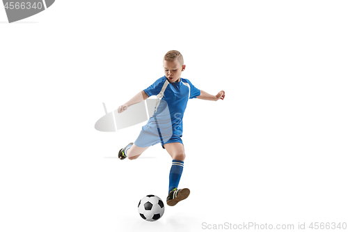 Image of Young boy with soccer ball doing flying kick