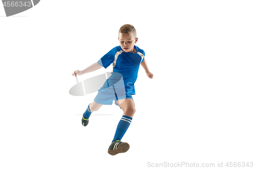 Image of Young boy with soccer ball doing flying kick