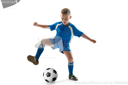 Image of Young boy with soccer ball doing flying kick