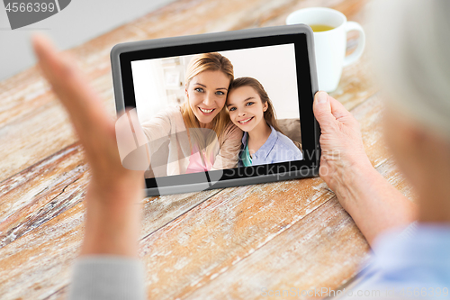 Image of family having video call on tablet computer