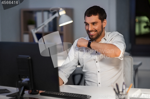 Image of businessman using voice command on smart watch