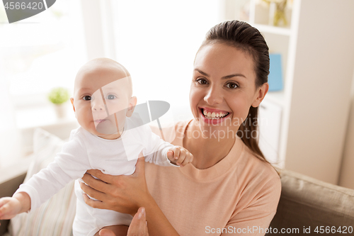 Image of happy mother with little baby boy at home