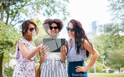 Image of women with tablet computer on street in summer