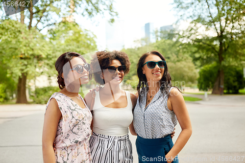 Image of happy young women in sunglasses at summer park