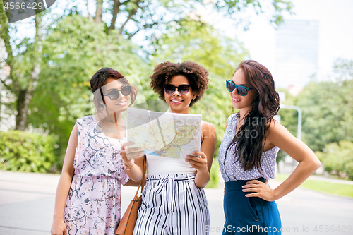 Image of happy women with map on street in summer city