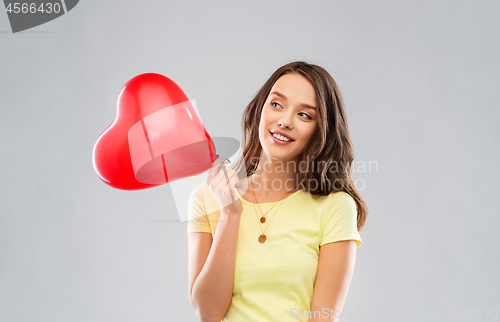Image of teenage girl with red heart-shaped balloon