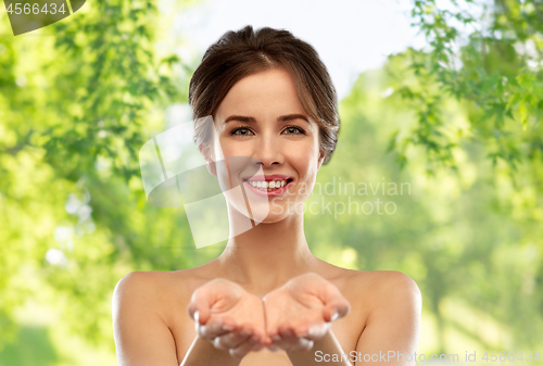 Image of smiling young woman holding something imaginary