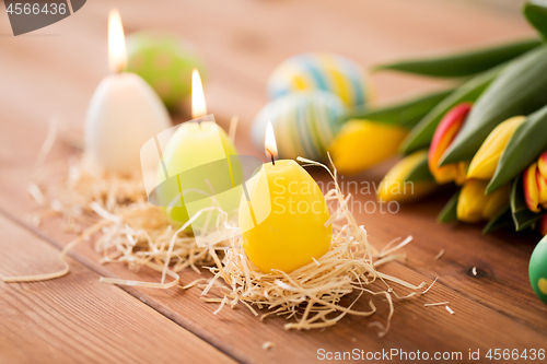 Image of candles in shape of easter eggs and tulip flowers