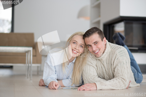 Image of Young Couple using digital tablet on cold winter day