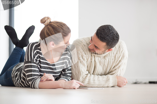 Image of Young Couple using digital tablet on cold winter day