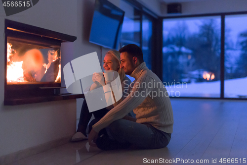 Image of happy couple in front of fireplace