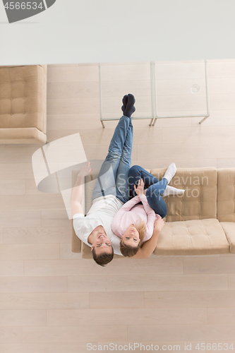 Image of Young couple on the sofa watching television top view