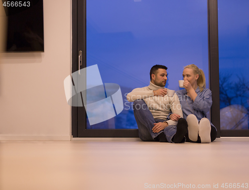 Image of happy couple in front of fireplace