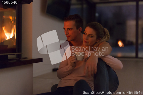 Image of happy couple in front of fireplace