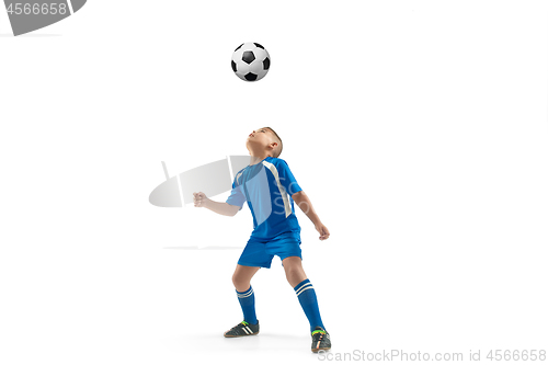 Image of Young boy with soccer ball doing flying kick