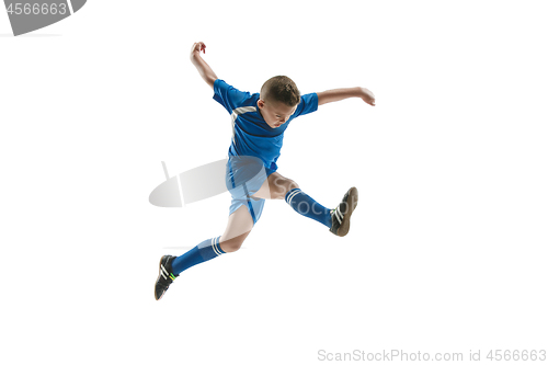 Image of Young boy with soccer ball doing flying kick