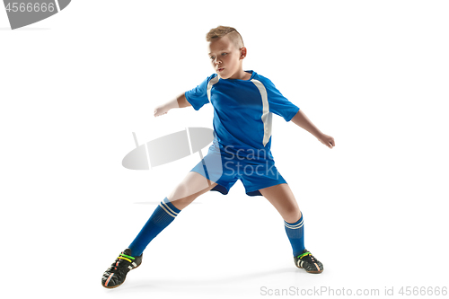 Image of Young boy with soccer ball doing flying kick