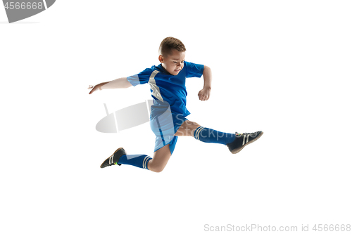 Image of Young boy with soccer ball doing flying kick