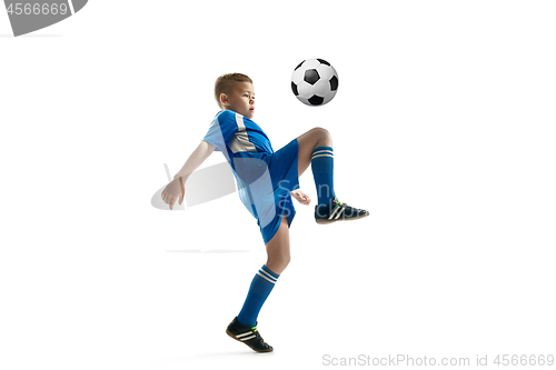 Image of Young boy with soccer ball doing flying kick