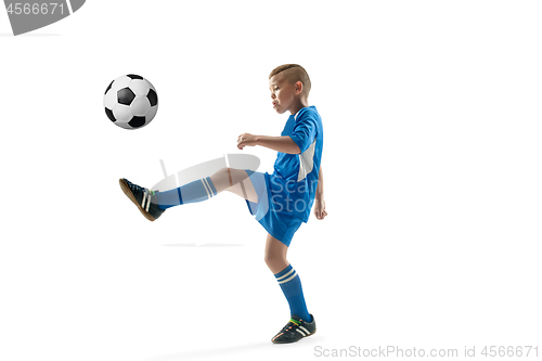 Image of Young boy with soccer ball doing flying kick