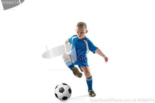 Image of Young boy with soccer ball doing flying kick