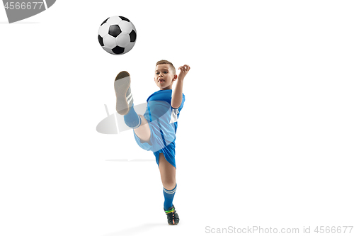 Image of Young boy with soccer ball doing flying kick