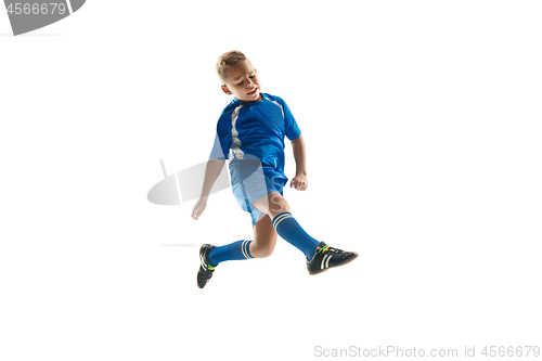 Image of Young boy with soccer ball doing flying kick