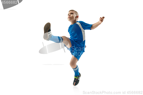 Image of Young boy with soccer ball doing flying kick