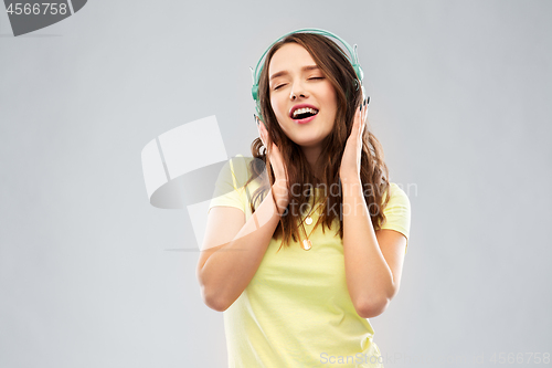 Image of happy young woman or teenage girl with headphones