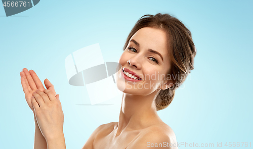 Image of smiling young woman over blue background