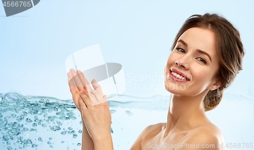 Image of smiling young woman over blue background