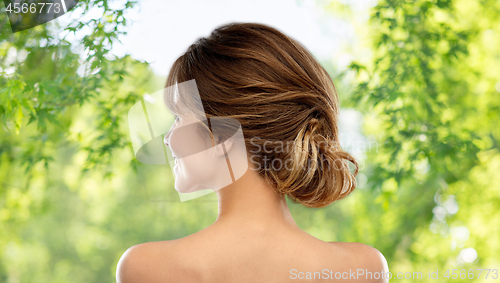 Image of young woman from back over grey background