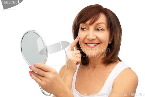 Image of portrait of smiling senior woman with mirror