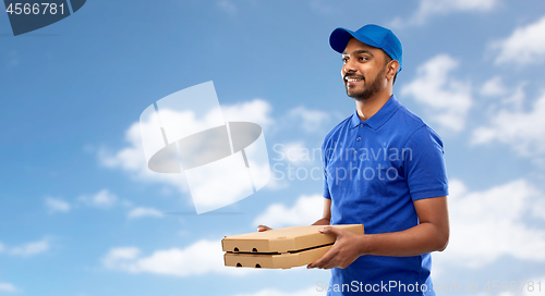 Image of happy indian delivery man with pizza boxes in blue