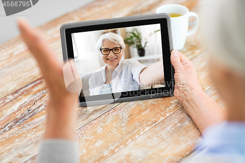Image of senior woman having video call on tablet computer