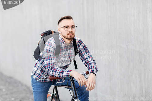 Image of hipster man with fixed gear bike and backpack