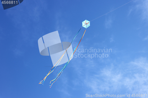 Image of Colorful kite flying and blue sky as background