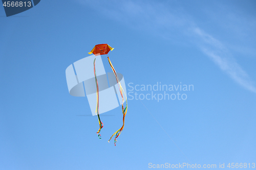 Image of Colorful kite flying and blue sky as background