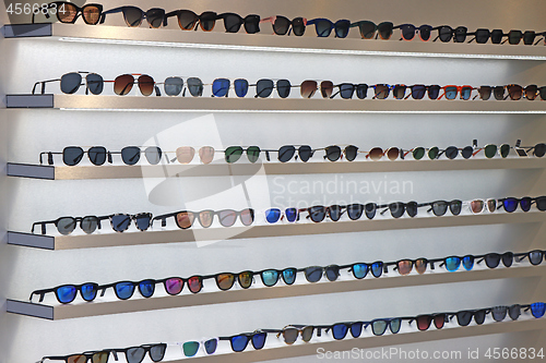 Image of Lot of sunglasses on the wall showcase